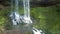 Waterfall cascade and brown stones on foreground