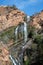 WATERFALL CASCADE FALLING DOWN A TIERED CLIFF