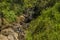 A waterfall cascades down a hillside in the tea country of Sri Lanka, Asia