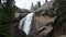 Waterfall cascades over rocks in the mountains