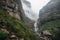 waterfall cascading over canyon walls, with mist in the air