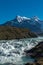 Waterfall cascading with a thunderous roar with a mountain range in the background, Torres del Paine, National Park, Chile