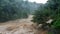 Waterfall cataract in forest mountains. Dirty streams are flowing down the mountain slopes of the mountain forest after heavy