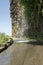 Waterfall on closed old road on the edge of rocky cliff between Ponta do Sol and Jardim do Mar, Madeira island, Portugal