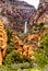 Waterfall coming down the colorful sandstone mountains in Oak Creek Canyon along Arizona SR89A between Sedona and Flagstaff