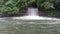 Waterfall dam draining water spillway mountain river with stone rushing waterfall stream