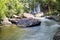 Waterfall in the deep forest. Huai Luang waterfall middle of the humid forest at Ubon Ratchathani, Thailand, Asia. Leaf moving low