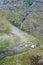 Waterfall in the distance. Z shapes and textured landscape. Rocky landscape with some trees