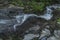 Waterfall on Divoky creek near Kouty nad Desnou village in summer day