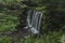 Waterfall on Divoky creek near Kouty nad Desnou village in summer day