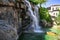 Waterfall on the embankment of Alanya Marina Turkey close-up. Landscaping with streams of water over stones on the street of a