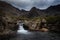 Waterfall in the Fairy Pools on the Isle of Skye under a stormy sky, Scotland, United Kingdom