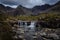 Waterfall in the Fairy Pools on the Isle of Skye under a stormy sky, Scotland, United Kingdom