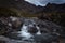 Waterfall in the Fairy Pools on the Isle of Skye under a stormy sky, Scotland, United Kingdom