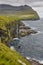 Waterfall in Faroe islands coastline. Vidareidi village in Vidoy