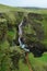 Waterfall at Fjadrargljufur Canyon, river cutting through green rocks, Iceland