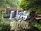 waterfall flowing in the deep forest, shady atmosphere.