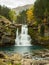 Waterfall flowing through the mountains in autumn