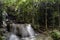 waterfall flows in the middle of the forest