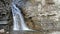 Waterfall flows through the rock