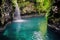 a waterfall flows into a serene hot spring pool