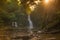 waterfall in the forest at sunset