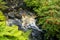 Waterfall with golden shimmering water, on the Isle of Skye