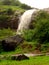 Waterfall on green hillside