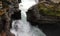 Waterfall of Gudbrandsjuvet gorge in Valldola valley on Trollstigen route in snow in Norway