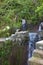 Waterfall and hiker in mountain landscape Madeira