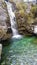 Waterfall between hills with rocks.