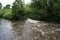 Waterfall inlet on canal in countryside image