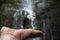 Waterfall in Jungle Taken Through Glass Ball Held in Hand