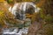 Waterfall among many foliage, In the fall leaves Leaf color change In Yamagata, Japan.Onsen atmosphere