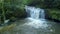 Waterfall in the middle of the forest shot over by drone