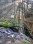 Waterfall in the middle of forest with sun light between tree taman hutan raya