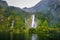 Waterfall in Milford Sound lake, New Zealand