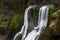 Waterfall among the mossy cliffs, Iceland