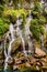 Waterfall from a mountain into a river in the Himalayas near Sapa, Vietnam