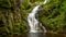 Waterfall in mountains.