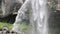 A waterfall over a grotto in a rock