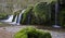 Waterfall over Mossy Rocks