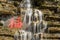 Waterfall over rocks and Chinese character. Translation `Luck`