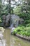 Waterfall over the rocks and into pond