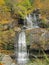 Waterfall in the park. Sunny day. Autumn time.