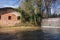 Waterfall and a pink picturesque wall of house near Isola Farnese, favorite walking place of Italians