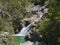 Waterfall of portela do homem running to green lake