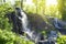 Waterfall in a public place on the Russian island under the rays of a bright sun