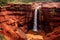 Waterfall in the Red Canyon of the Kings National Park, Australia, The famous Red Dirt Falls, a cascading waterfall of fresh water