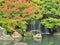 Waterfall and red leaves in autumn season at Koko-en garden, Himeji, Japan.